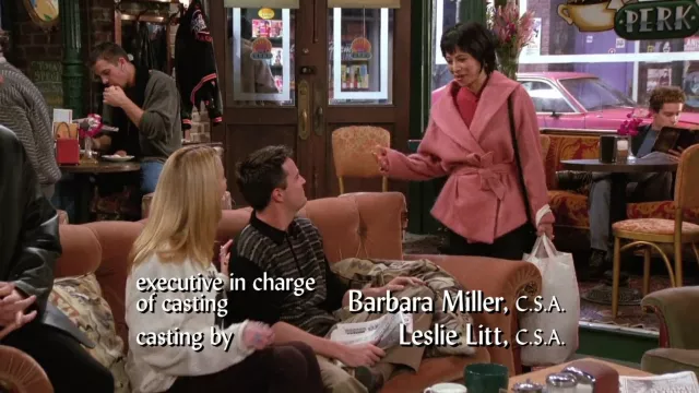Abrigo rosa envolvente usado por Julie (Lauren Tom) en la serie de televisión Friends (Temporada 2, Episodio 10)