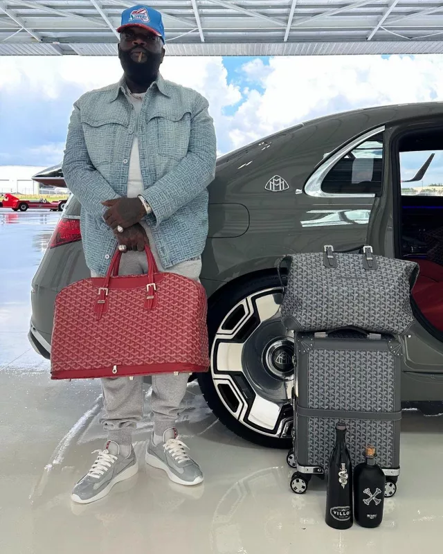 Goyard Grey Bourget Rolling Suitcase worn by Rick Ross on the Instagram account @richforever