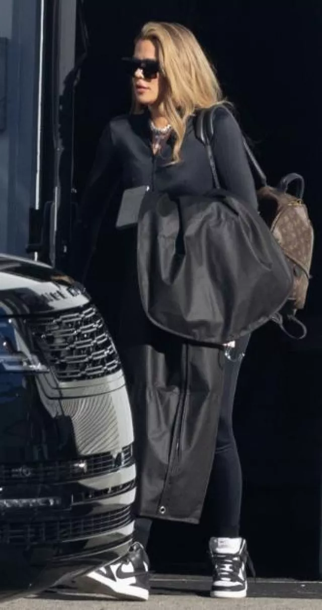 Louis Vuitton Monogram Canvas Palm Springs Backpack worn by Khloé Kardashian in Los Angeles on November 17, 2023