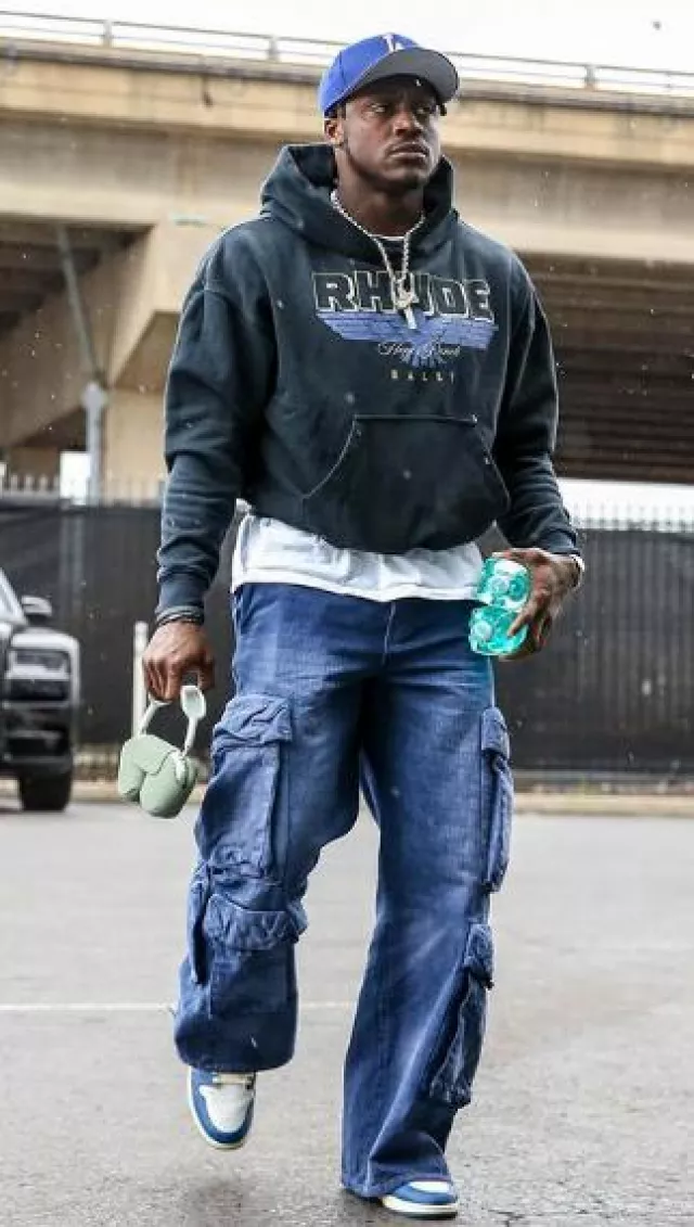 Amiri Blue Allover Logo Baggy Cargo Pants worn by A. J. Brown on the Instagram account @ajbtoday