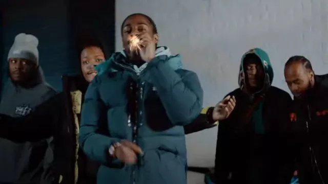 Take Risks & Prosper Navy & Turquoise-Hood Puffer Jack­et worn by Russ in Russ Millions x Fivio Foreign- Canarsie (Official Video)