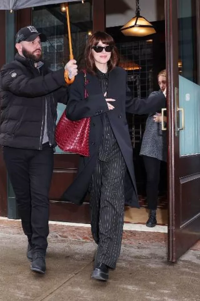 The Row Zipped 1 Leather Ankle Boots worn by Dakota Johnson in New York City on January 23, 2024