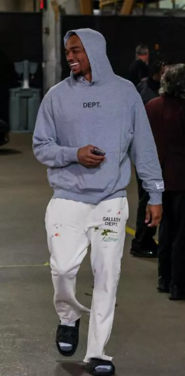 Gallery Dept. Cream Paint Splatter Flared Sweatpants worn by Paul Jamaine Washington Jr. on the Instagram account @dallasmavs