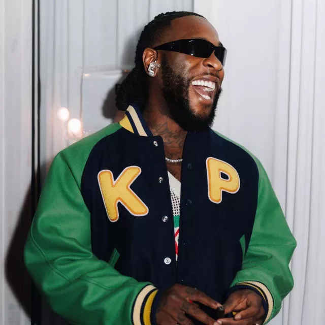 Prada Black Rectangular Wrap 'Symbole' Sunglasses (PRA19S) worn by Burna Boy on the Instagram account @burnaboygram