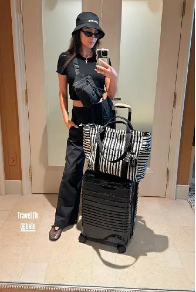 Beis The Vacation Tote In Black Stripe worn by  Shay Mitchell on her Instagram Story on July 23, 2024