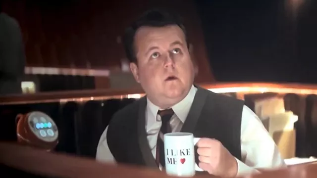 Deadpool & Wolverine Movie Outfits: TVA Tech (James Dryden) 
is using Funny I Like Me Coffee Cup