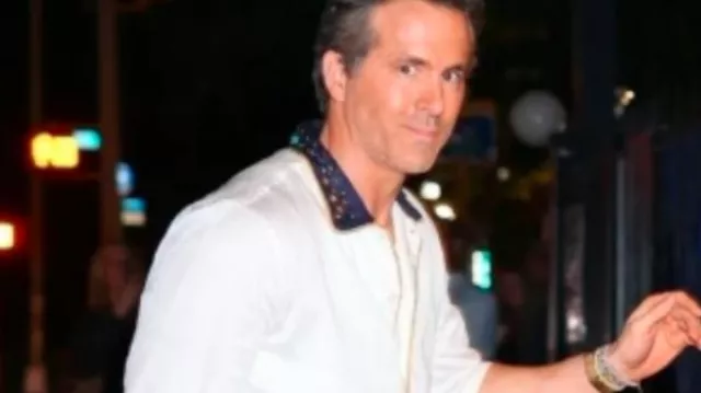 Ryan Reynolds wears white shirt with Navy collar on October 11, 2024 in New York City with Blake Lively