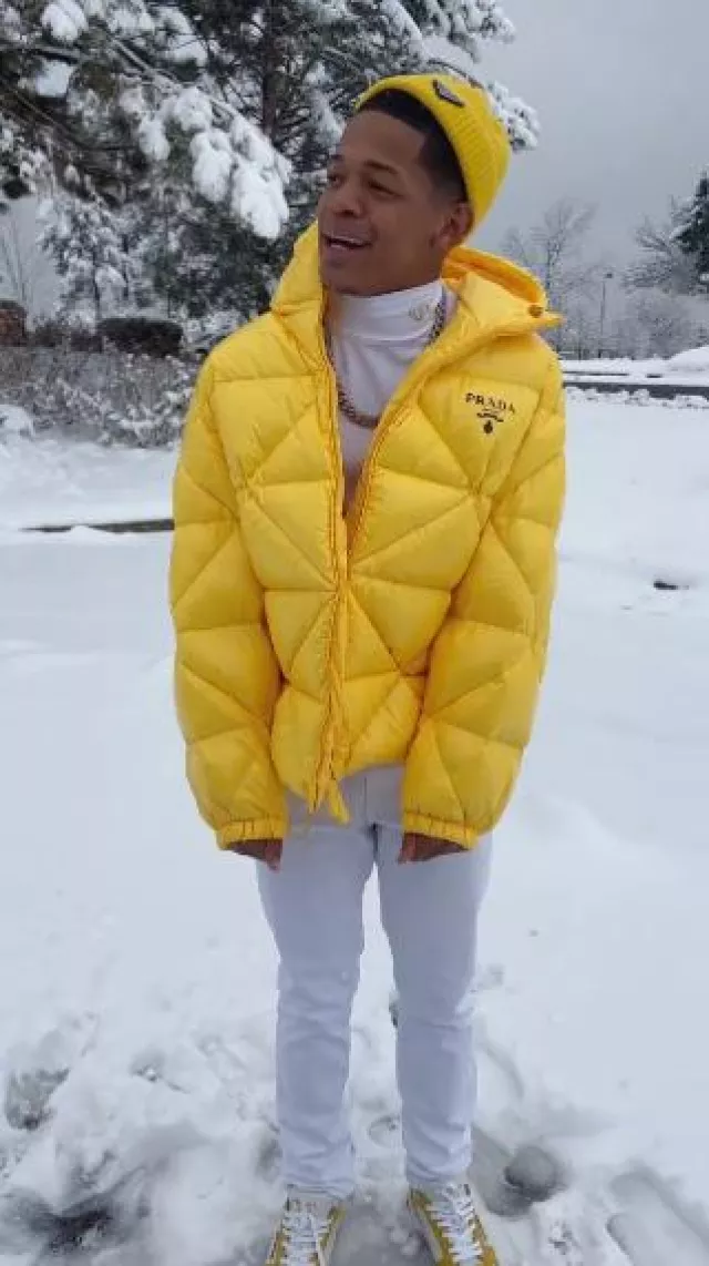 Prada Yellow Triangle Quilted Puffer Jacket worn by YK Osiris on the Instagram account @ykosiris