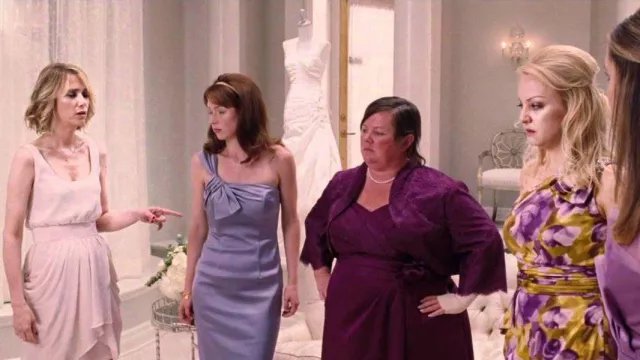 Wardrobe of Bridesmaids: Becca (Ellie Kemper) is wearing David Meister Purple Lilac Stretchy One Shoulder Party Dress