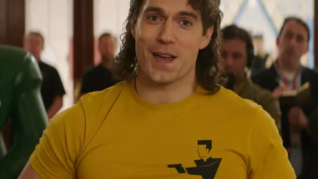 Atuendos de la película Argylle: Henry Cavill usa una camiseta amarilla con el logotipo abstracto de espías para jugar a Argylle