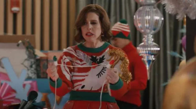 Planet Gold Juniors' Unicorn Christmas Tinsel-Embellished Sweater worn by DeeDee Dashers (Vanessa Bayer) as seen in Elsbeth (S02E06)
