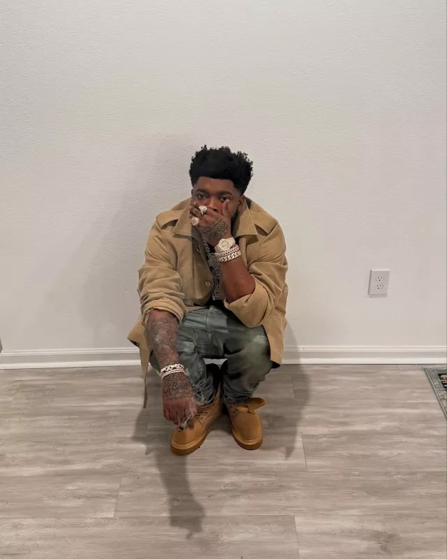 Louis Vuitton Beige Mini Monogram LV Ranger Boots worn by BossMan Dlow on the Instagram account @bossman_dlow