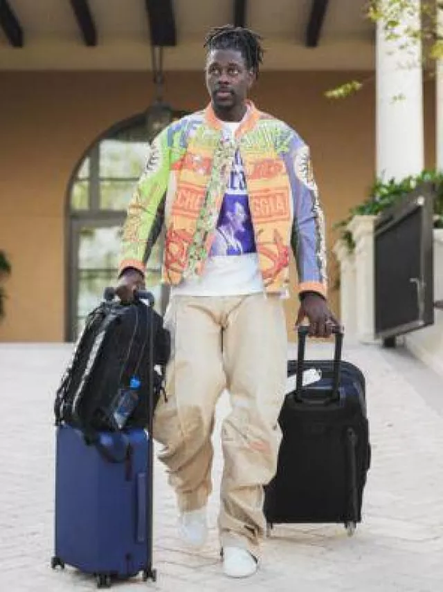 Ogio Black Canvas Terminal Rolling Travel Bag worn by Jrue Holiday on the Instagram account @celtics