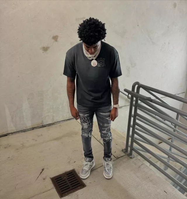 Amiri Storm Grey Staggered Logo 'Repair' Jeans worn by Yungeen Ace on the Instagram account @yungeenace