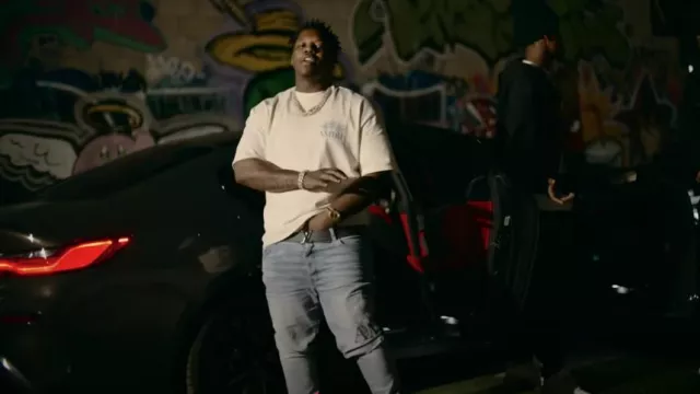 Amiri Perfect Indigo Starburst Logo Jeans worn by Lil Zay Osama in Lil Zay Osama - "Crash Out" (Official Video)