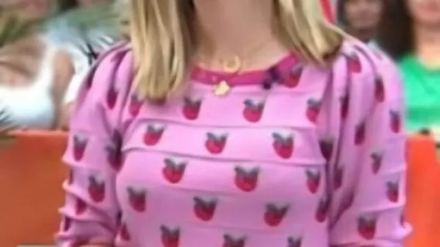 The Today Show Pink Strawberry Print Sweater worn by Jill Martin in the YouTube video Steals And Deals For Fall Fashion: Stylish Sunglasses, Cozy Shawls, And More | TODAY