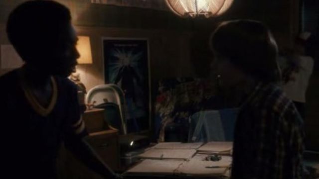 The poster for the movie The Thing on the wall in the basement of Mike Wheeler (Finn Wolfhard) in Stranger Things S01E01