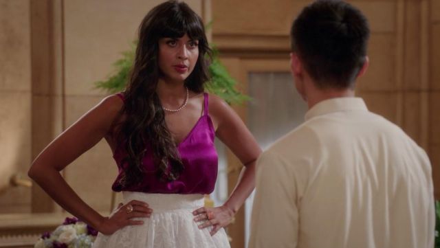 The top V-neck pink satin of Ms. Al-Jamil (Jameela Jamil) in The Good Place S02E04