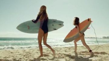 Surfboards, Nancy, and his sister at the end of The Shallows