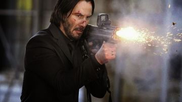 The black strap of the assault rifle of Keanu Reeves in John Wick