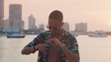 The black shirt with the scriptures (style tag) worn by Naps in the clip the official One Is Made For It