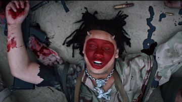 Silver necklace with a monster pendant worn by Trippie Redd as seen in his Under Enemy Arms music video