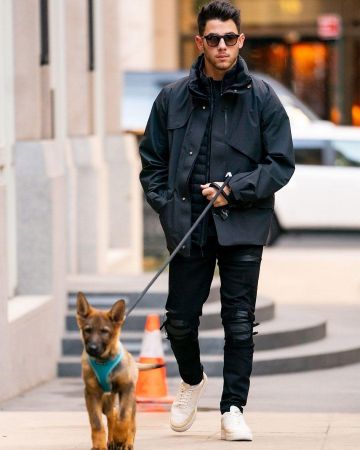 Black Asymmetrical coat worn by Nick Jonas on the Instagram account of @britishgq