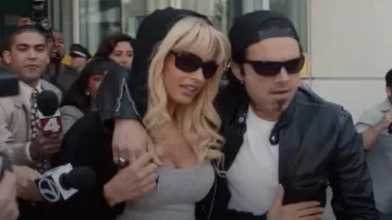 Black sunglasses worn by Pamela Anderson (Lily James) as seen in Pam & Tommy TV series wardrobe (Season 1)