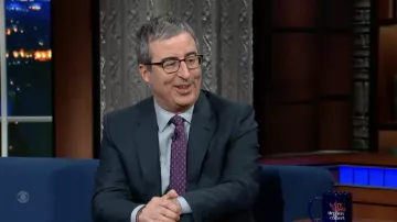 Black eyeglasses worn by John Oliver as seen in The Late Show with Stephen Colbert on February 15, 2022