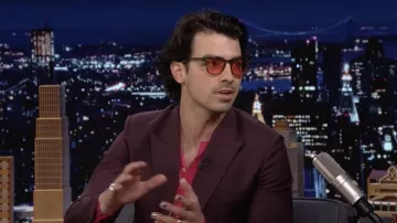 Red sunglasses worn by Joe Jonas as seen in The Tonight Show Starring Jimmy Fallon on March 23, 2022