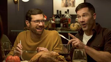Suéter de mostaza amarilla usado por Bobby Leiber (Billy Eichner) como se ve en los atuendos de las películas de Bros