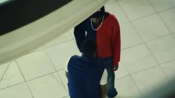 The blue and red sweater worn by Cam (Alexander Blake) in the series Top Boy (Season 1 Episode 2)