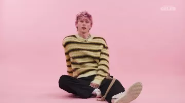 Yellow and black striped sweater worn by Machine Gun Kelly in MGK Plays With Puppies While Answering Fan Questions YouTube video