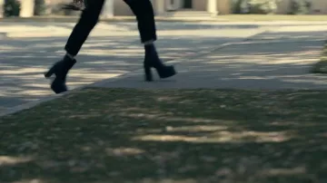 Black lace-up boots with heels worn by Cassie (Sofia Carson) in Our Bruised Hearts