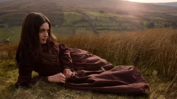 Brown long sleeve dress worn by Emily Brontë (Emma Mackey) as seen in Emily movie