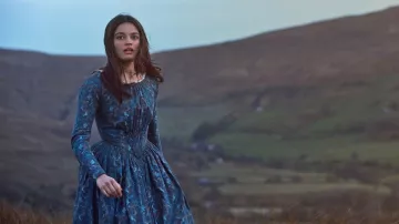 Blue printed dress worn by Emily Brontë (Emma Mackey) as seen in Emily