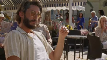 The striped beige shirt worn by Adrien Saillard (Pierre Niney) in the film Mascarade