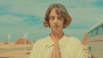 Yellow flower cardigan worn by Maya Hawke as seen in Asteroid City