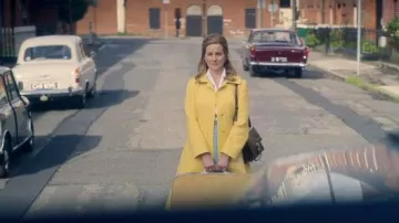 Yellow coat worn by Chrissie (Laura Linney) as seen in The Miracle Club movie