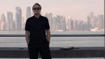 Navy blue zippered polo shirt with vertical stripes worn by Nathan (Cary Elwes) in the movie Operation Fortune: The Great Deception