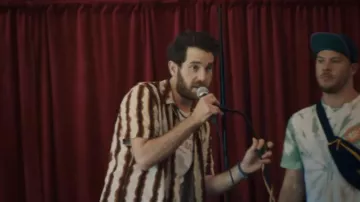 Striped shirt worn by Amos Klobuchar (Ben Platt) as seen in Theater Camp movie outfits