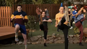 Cobra Kai Wardrobe: Robby Keene (Tanner Buchanan) is wearing Vans Black Tee in season 6, episode 2