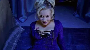 Bride of Chucky Movie Outfits: Tiffany (Jennifer Tilly) wears Purple lace up top