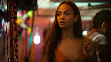 Emilia Pérez Movie Outfits: Rita Moro Castro (Zoe Saldana) is wearing Pendant Necklace