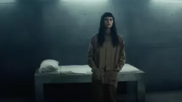 Costumes from The Platform 2 Movie: Milena Smit wears brown jumpsuit