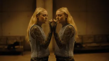 The looks of the movie The Watchers: Dakota Fanning wears a blouse under sweater for her role of Mina / Lucy