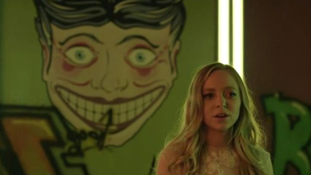 The stickers of the heads on the wall of the cue of Mr. Robot