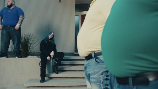 Black cargo pants with black straps attached to the legs worn by Billie Eilish in her Bad Guy music video
