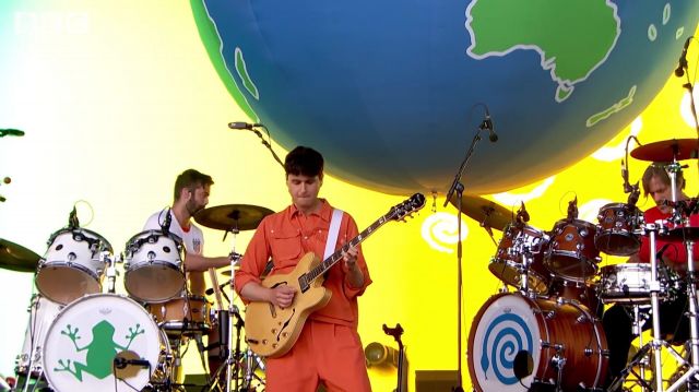 Orange suit worn by Ezra Koenig for This Life performance by Vam­pire Week­end at Glas­ton­bury Festival 2019
