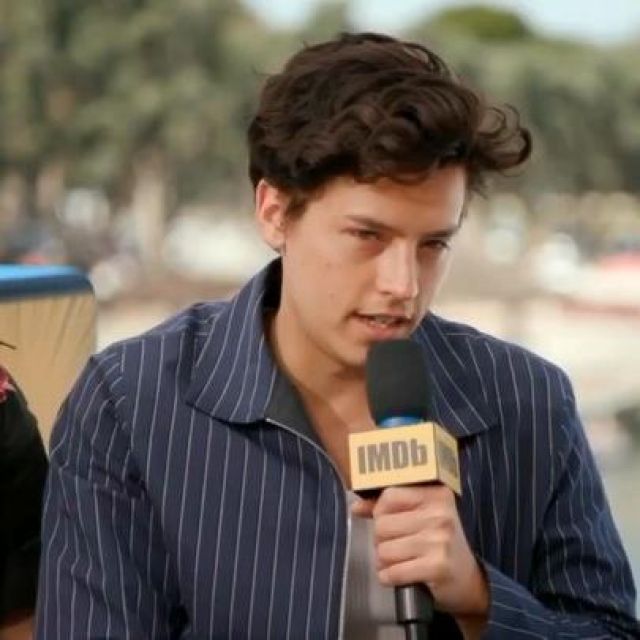 Blue jacket with white stripes worn by Cole Sprouse for an IMDb interview at the Comic-Con 2019